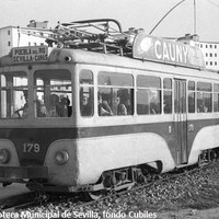 24. Línea de tranvía y carretera a San Juan de Aznalfarache, 1958. Las barriadas lindaban por la parte más cercana al río con una vía férrea destinada a transporte de carburantes y al tranvía en dirección a la Puebla del Río cuya línea se inauguró en 1932. En febrero de 1965 dejó de prestar servicio interurbano. ©ICAS-SAHP. Fototeca Municipal de Sevilla, fondo Cubiles